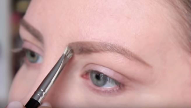 Woman colouring in her eyebrows 