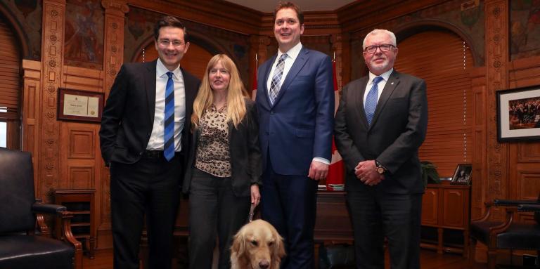 CNIB’s Diane Bergeron, Vice President of Engagement and International Affairs, stands with Members of Parliament Pierre Poilievre and Andrew Scheer.