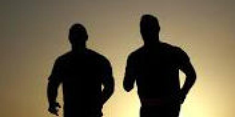 Two men running side by side