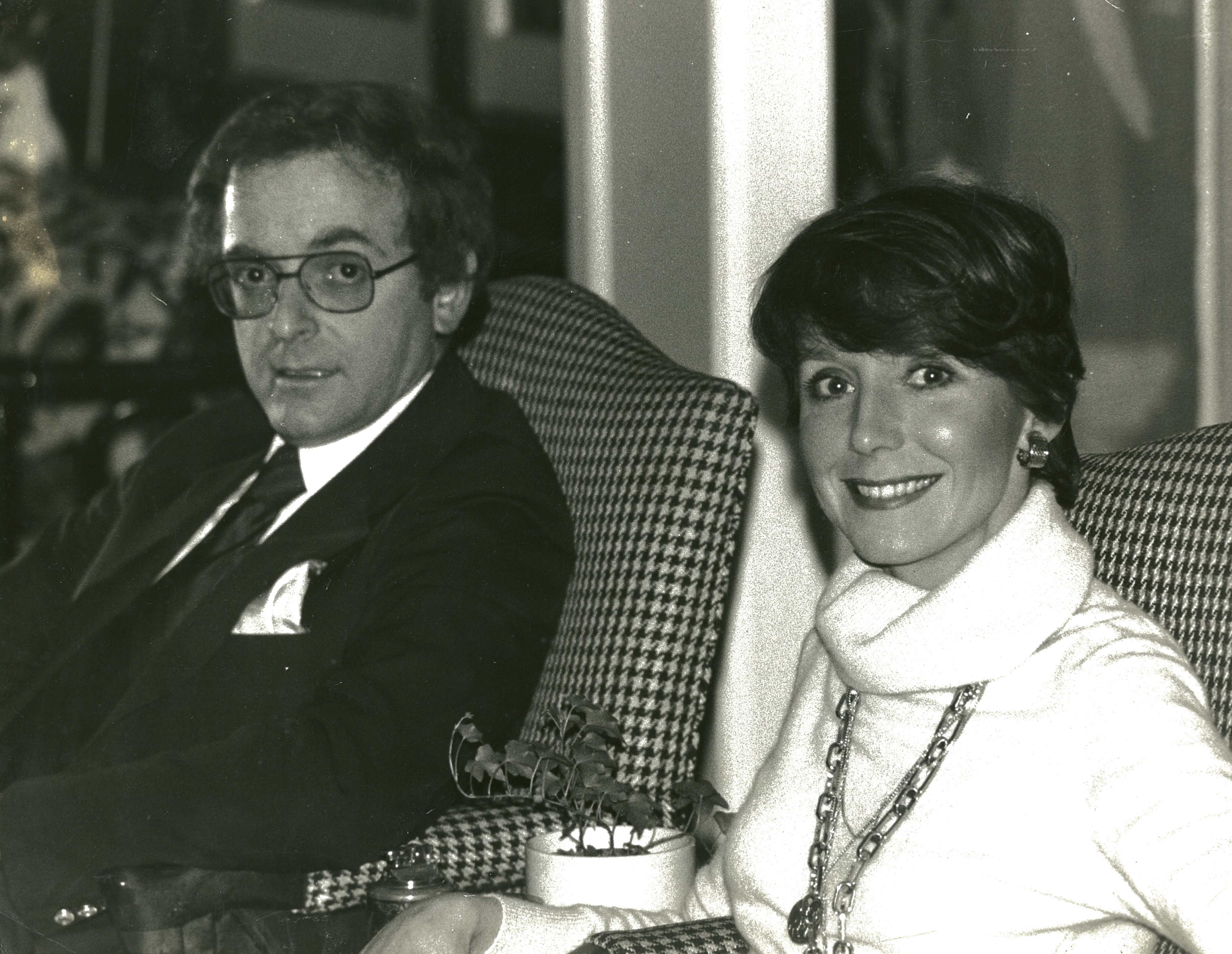 A black and white photo of a young Howard and Delores Beck sitting on matching armchairs