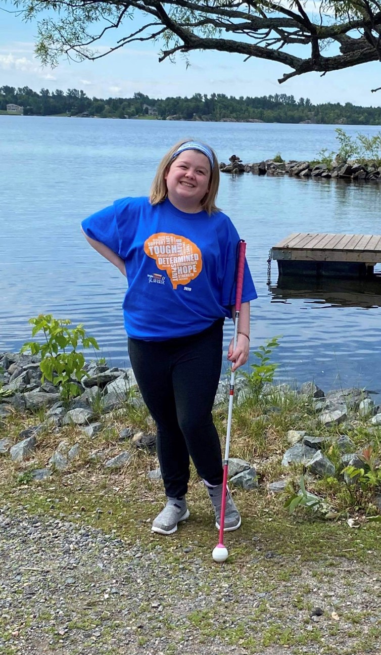 AliciaAlicia poses with her white cane outdoors at a Brain Tumour Foundation fundraising event. 