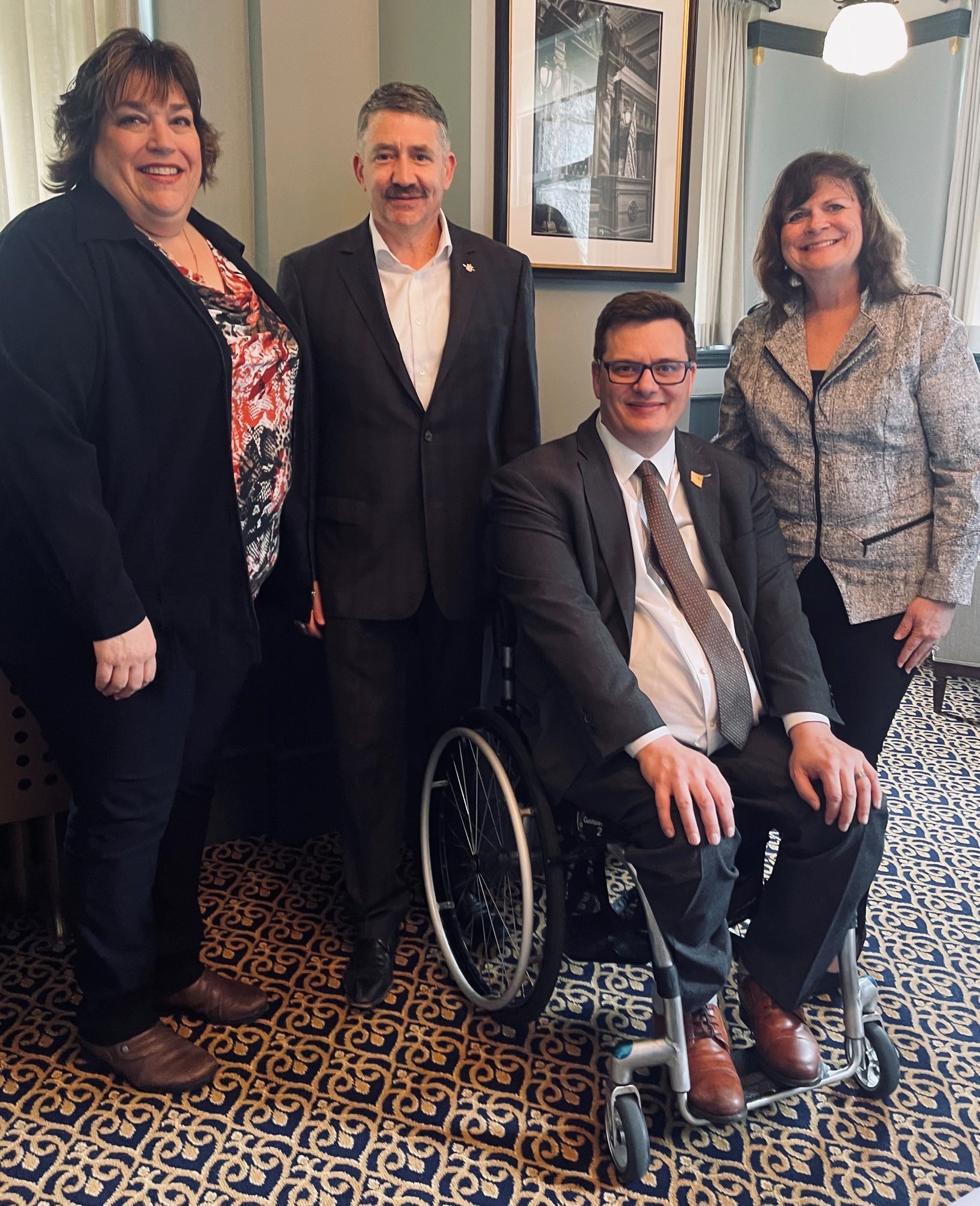 Sherry Grabowski, Vice President of CNIB Deafblind Community services poses with Dan Coulter, Nicholas Simons, and Theresa Tancock