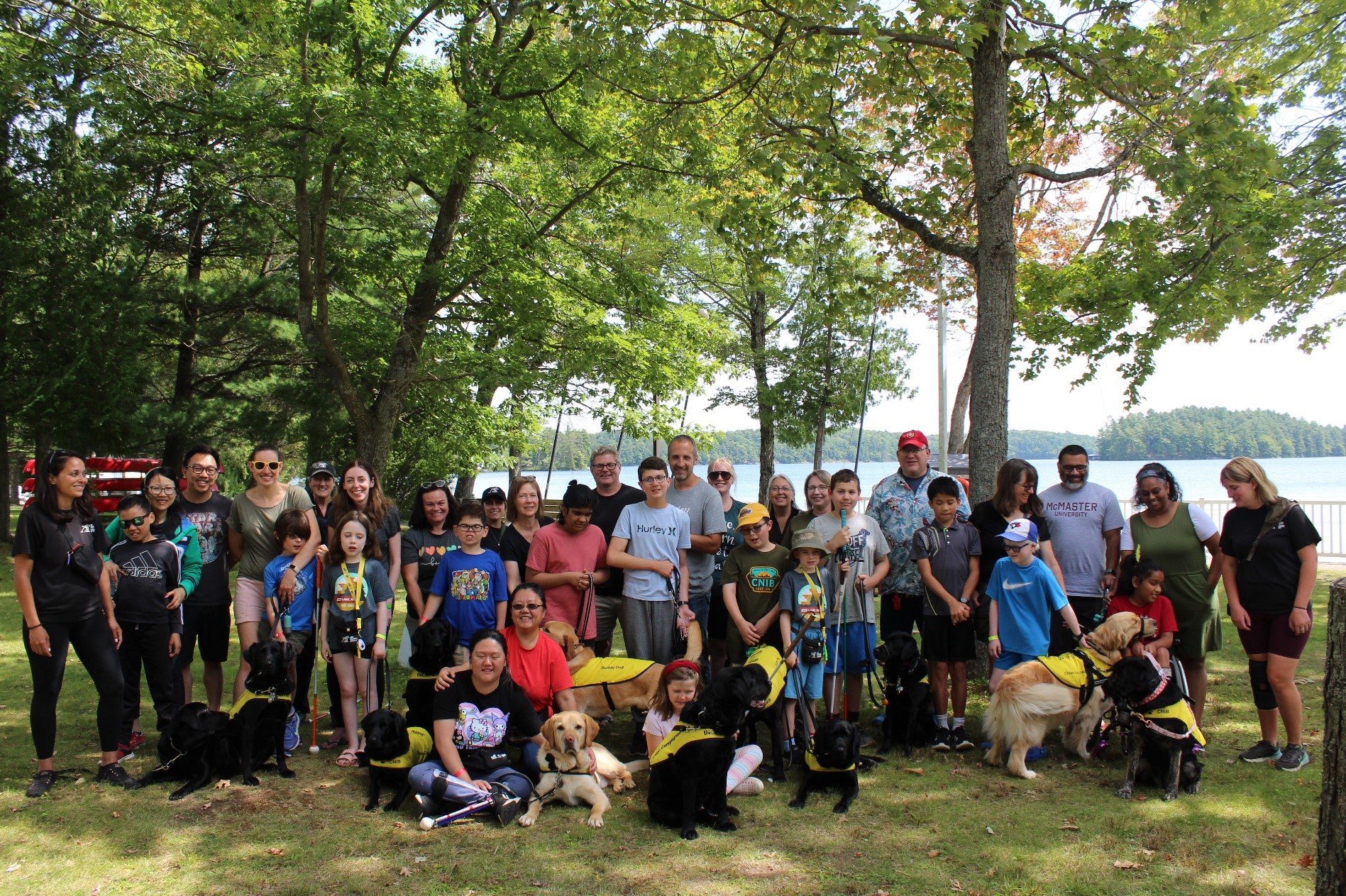 A large group of campers smiling together and taking a picture at lake joe