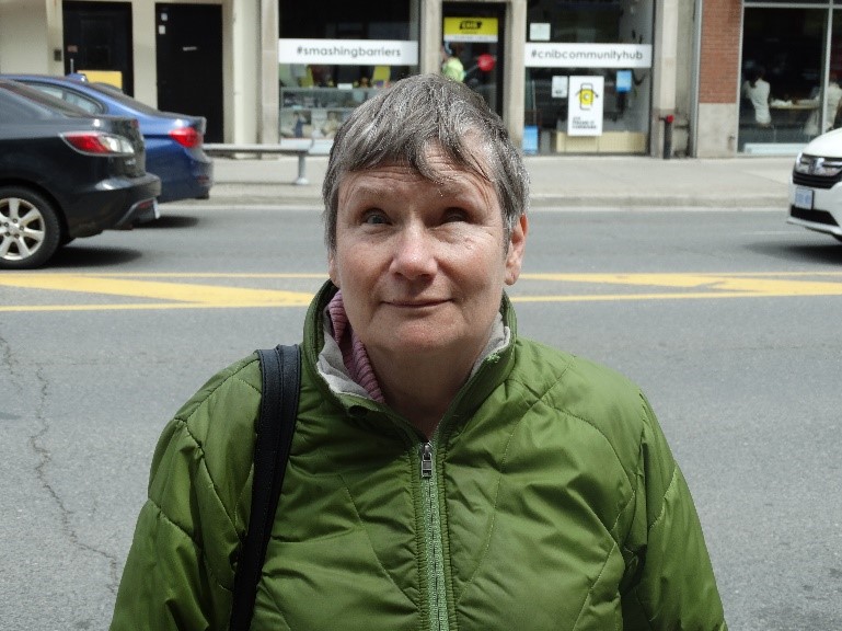 A photo of Debbie Gillespie standing outside the CNIB Toronto Community Hub.
