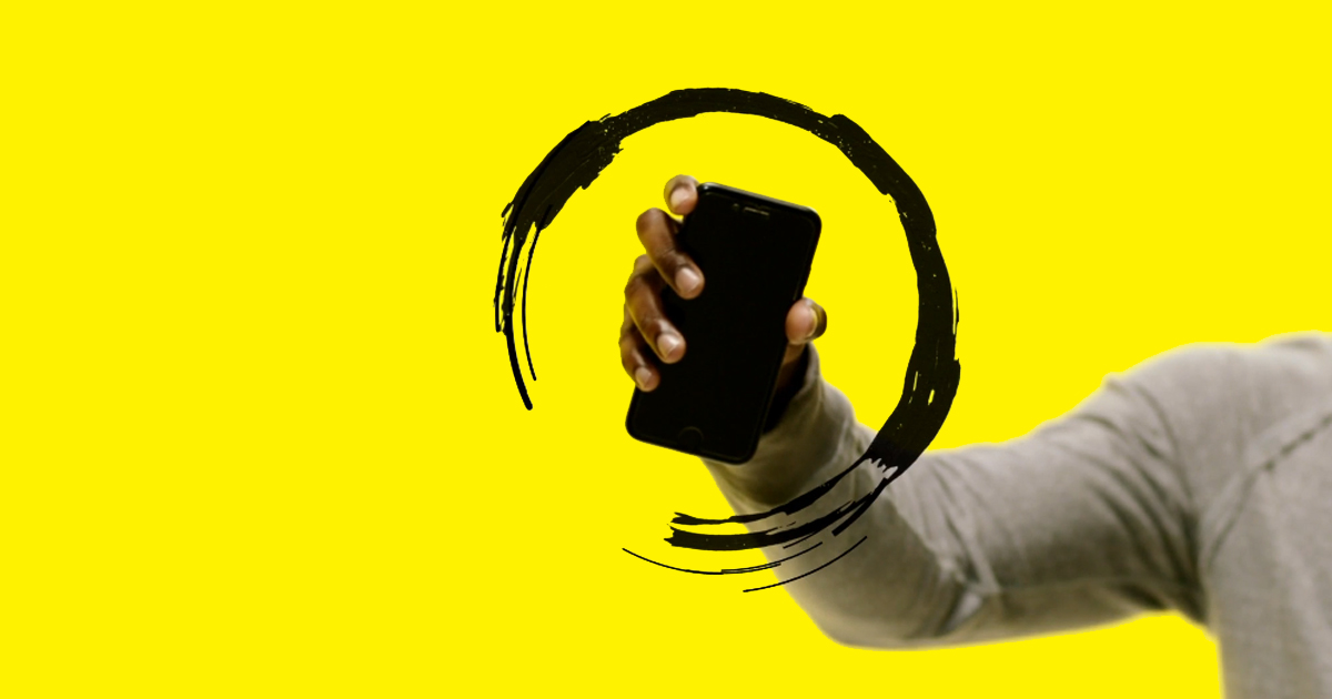 A hand holds a smartphone up in the air. The phone is surrounded by an illustration of a circular black swirl.