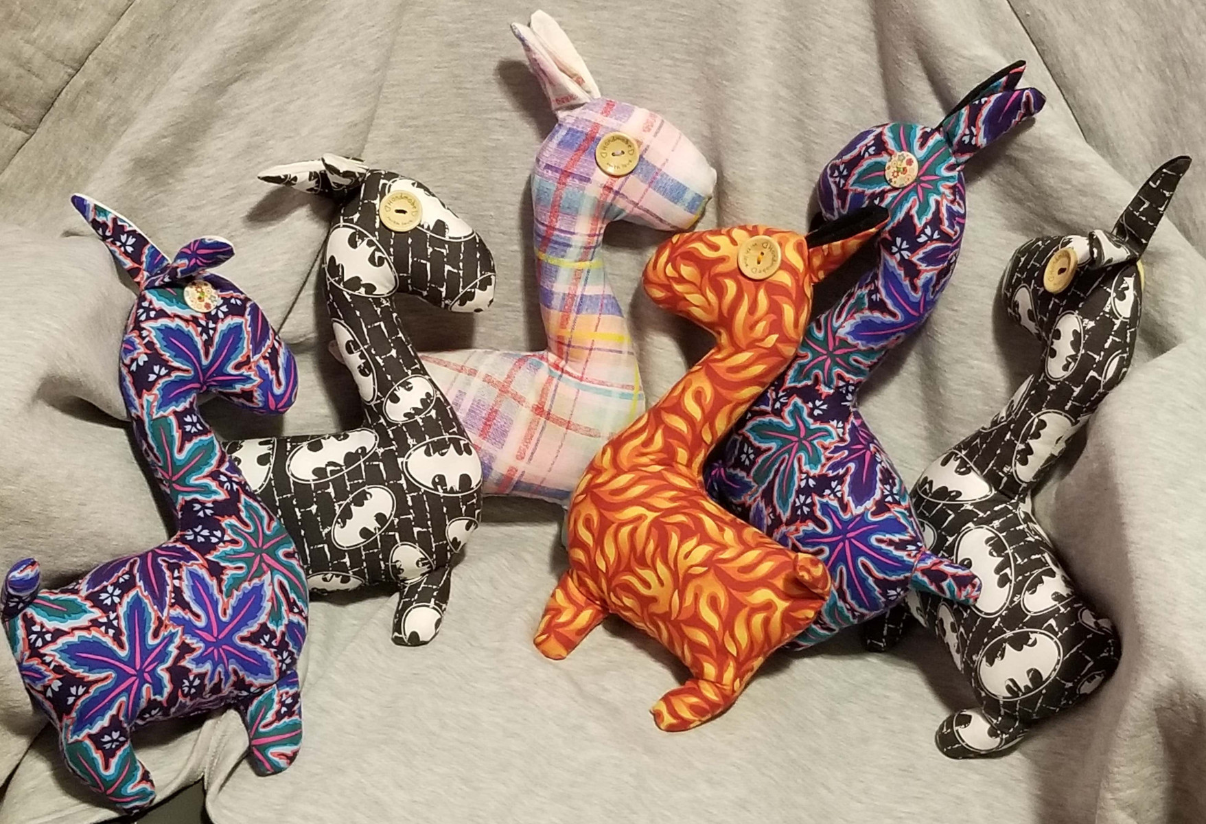Six colourful stuffed animal Llamas, created by Jaclyn. The llamas have tactile elements like button eyes. 