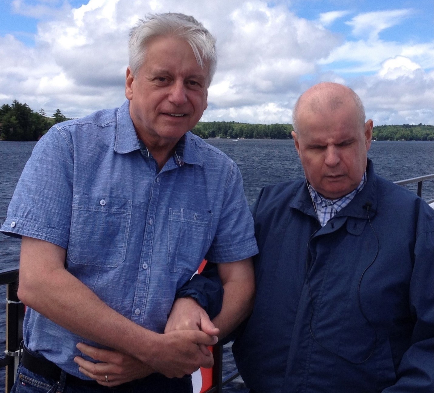 Rob Froom (left) standing waterside at Lake Joe with his brother David Froom. Rob is holding his brother's hand.