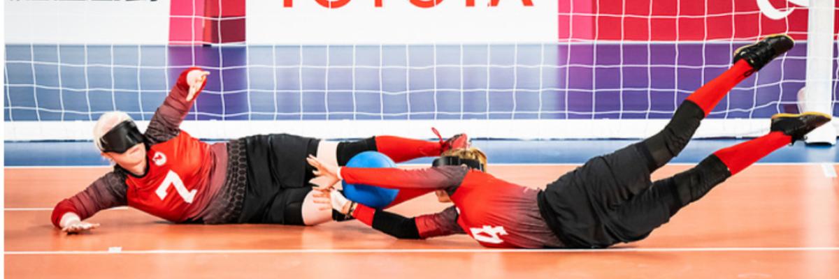 Les athlètes de goalball de l'équipe canadienne Amy Burk, à gauche, et Meghan Mahon, à droite, plongent vers un ballon devant un filet pendant les Jeux paralympiques de Tokyo 2021. Image gracieusement fournie par le Comité paralympique canadien.