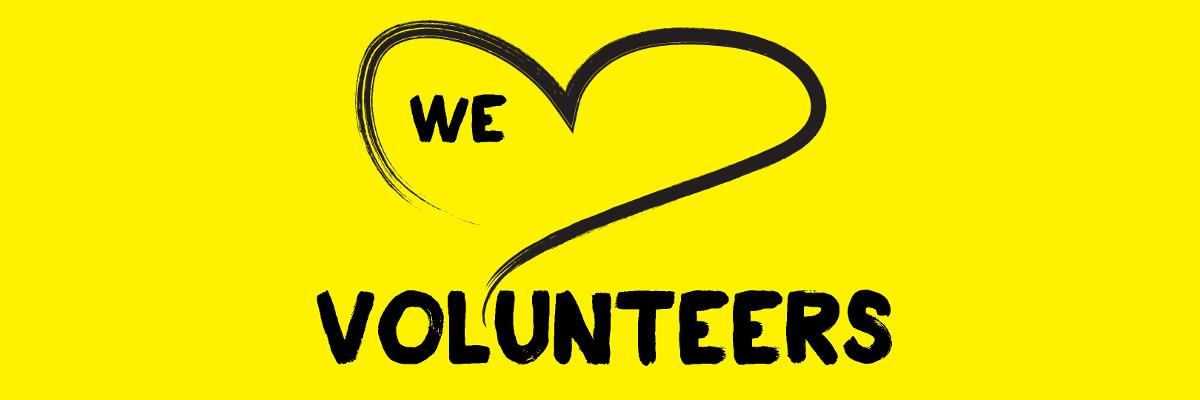 A yellow banner feat an illustration of a heart outlined in a black paintbrush style design. Text: We heart volunteers! 