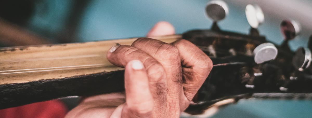 A hand playing guitar