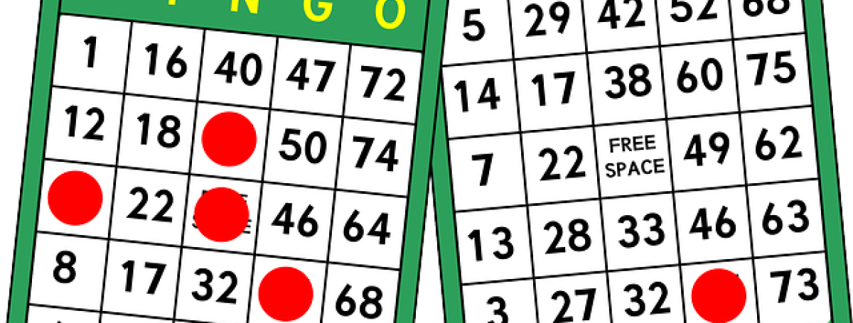 An illustration of two bingo cards and red, circular, chips marking the card.