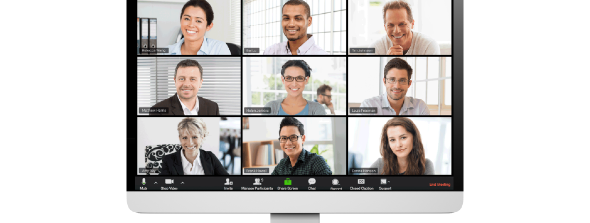 A computer monitor displays multiple video streams featuring people video-conferencing at home.