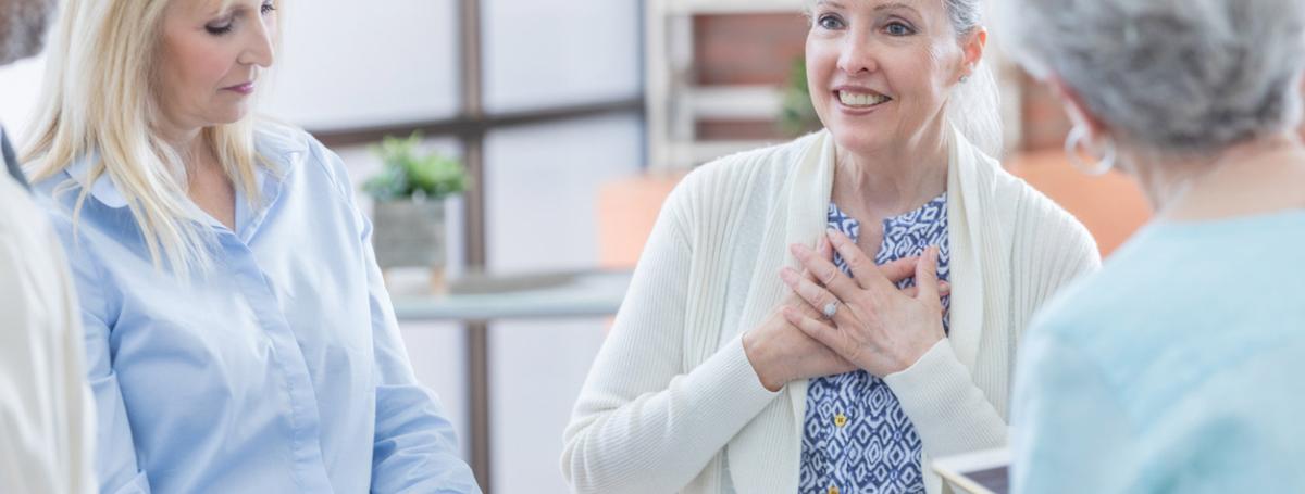 A peer support group. Three elderly women engage in lively conversation.