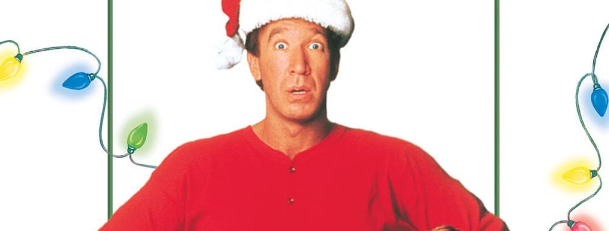 The movie poster for "The Santa Clause." Tim Allen wears a red jumpsuit and a Santa hat.