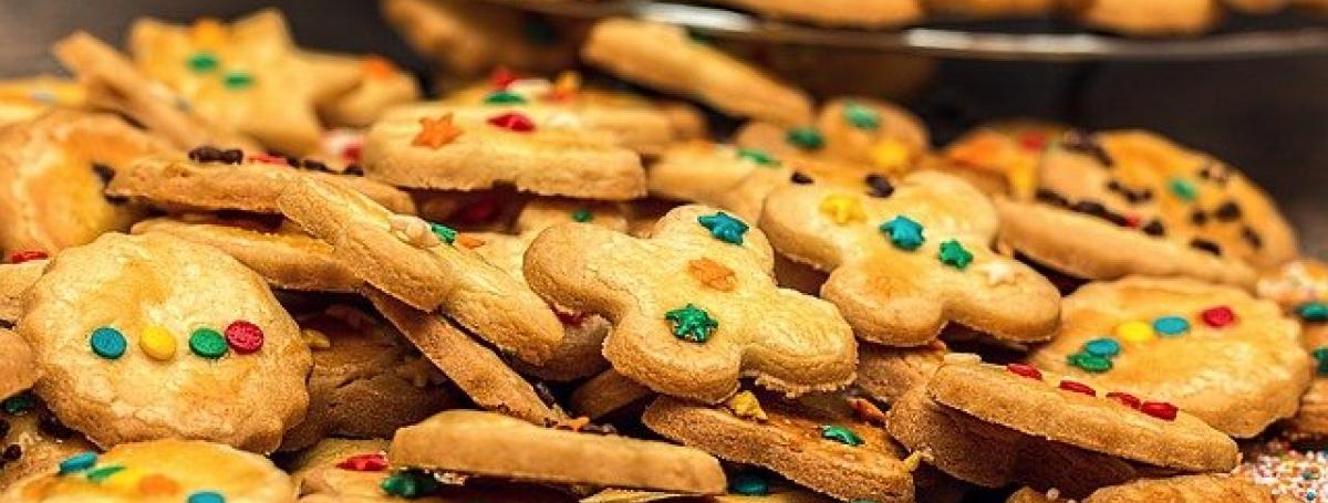 A large batch of delicious cookies decorated with holiday sprinkles.
