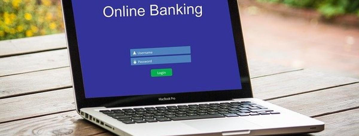A laptop computer displays an online banking module.
