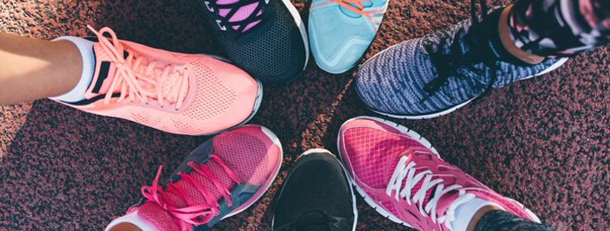 Six colourful running shoes stacked side-by-side in a circle.