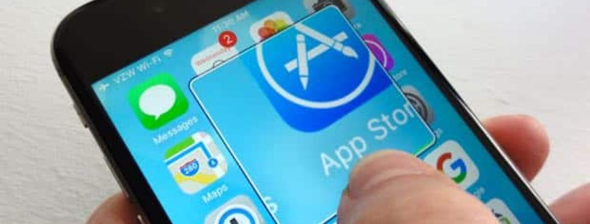 An iPhone screen displays a magnified app.