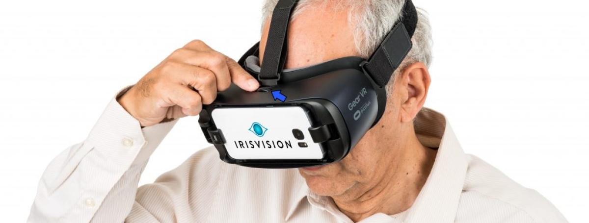 An older man wears an IrisVision headset.