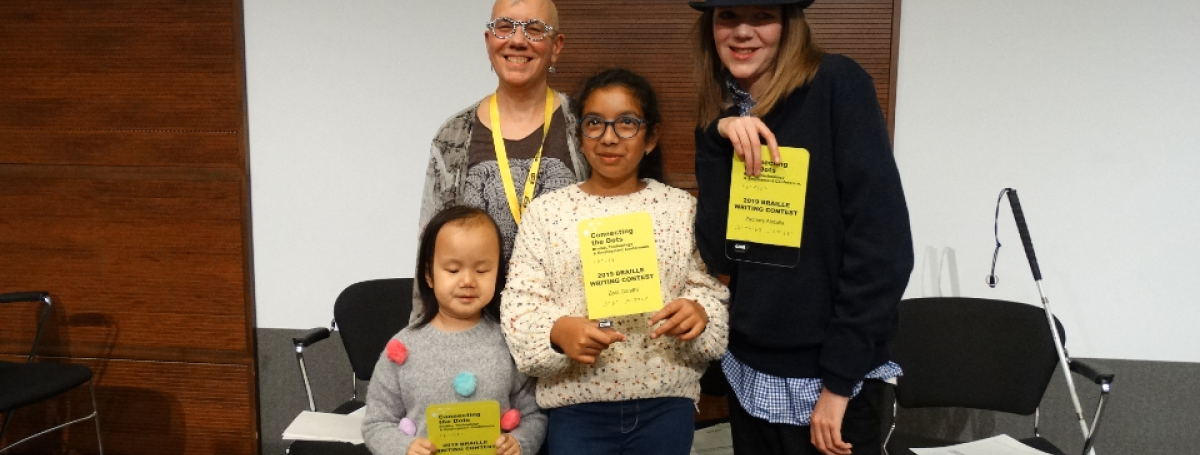 Winners from the 2019 Braille Creative Writing Contest Kelsey, Zara and Zachary pose for a photo with Karen Brophey. They are holding their awards!