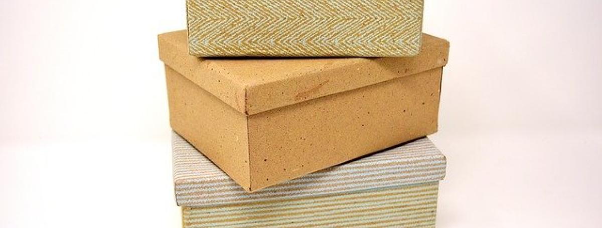 Three cardboard boxes stacked on a table top.
