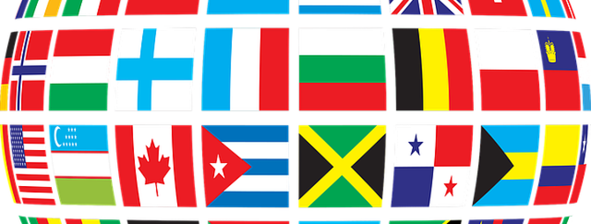 An illustration of a globe made up of a mosaic of different flags from countries around the world.