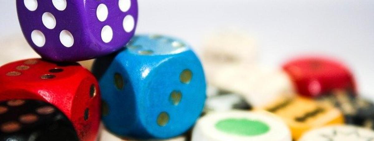 A pile of colourful dice and other game pieces.