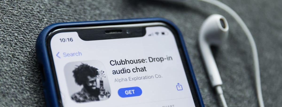 An iPhone displays the Clubhouse app.