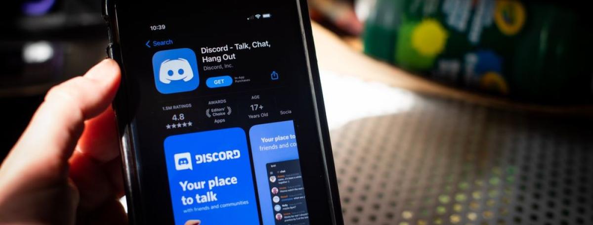 A smartphone displays the Discord app.