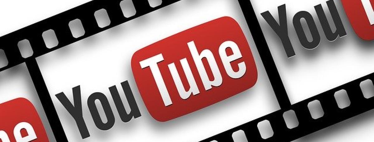 An illustration of a film reel. YouTube's logo is displayed within the reel.