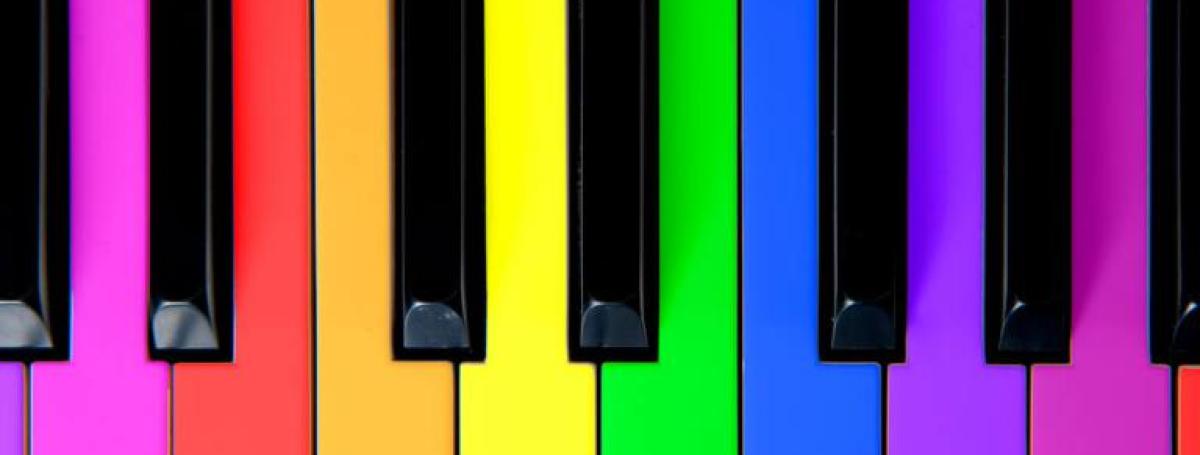 A piano keyboard. Each key is in a different bright rainbow colour.