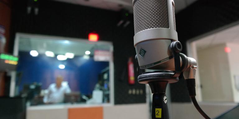 Image of a microphone placed in a recording studio. 