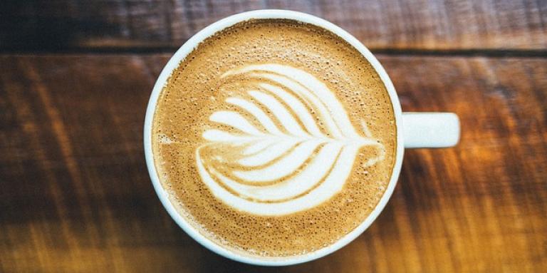 A coffee cup sits on a table. 