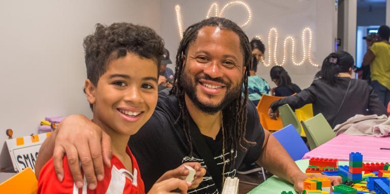 a man builds Lego with a boy