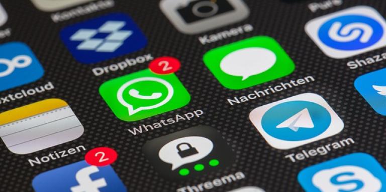 An iPhone homescreen with various apps displayed.