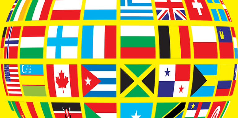 An illustration of a globe made up of a mosaic of different flags from countries around the world.