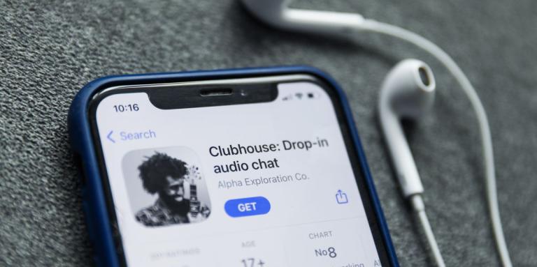 An iPhone displays the Clubhouse app.