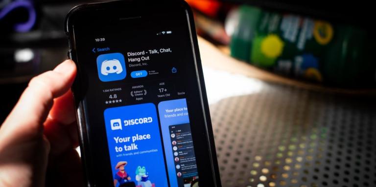 A smartphone displays the Discord app.