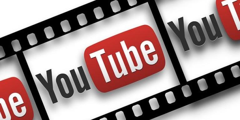 An illustration of a film reel. YouTube's logo is displayed within the reel.