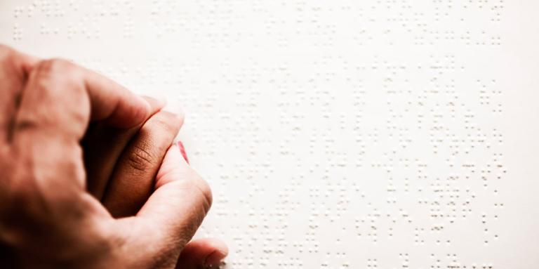 Hands reading braille