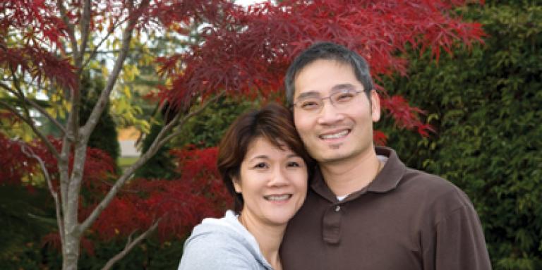 couple d’âge moyen souriant, à l’extérieur