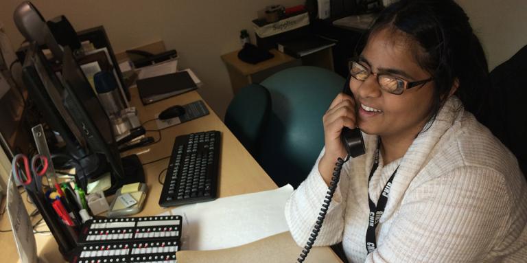 Shruti helping a caller at reception