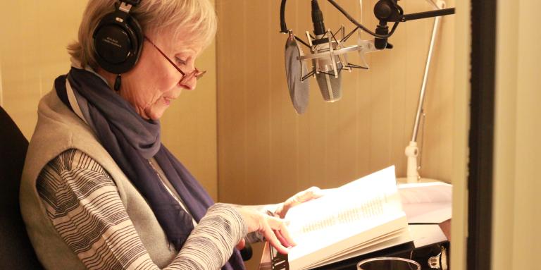 Celine Garneau, reading from a book in one of CNIB’s recording studios. 