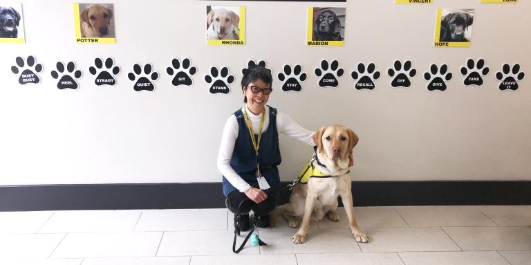 Puppy Raiser Yuko Imai, kneeling next to Potter, a future CNIB Guide Dog