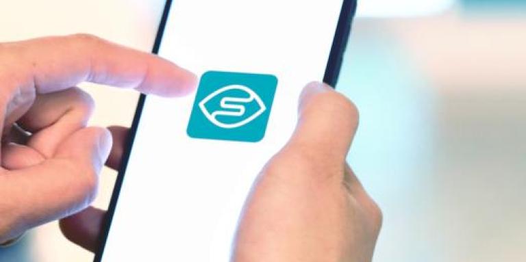 An iPhone 11 screen displays the Seeing AI app.