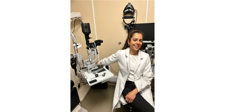 Dr. Danah Al-Breiki, Opthamologist sitting in a doctor office with a white lab coat on