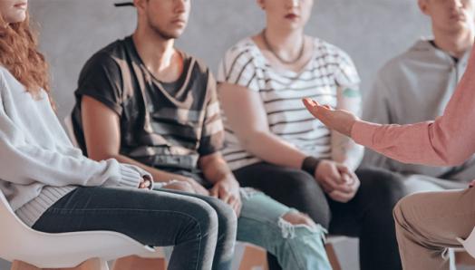 A group of people sit in a circle.