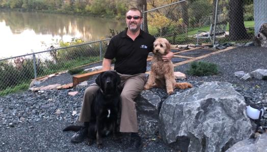 Tracy with Marion, black Labrador Retriever and Autumn, Tracy’s pet dog.