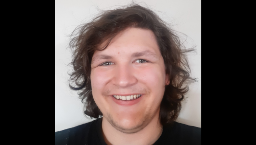 A selfie photograph of Tait smiling.