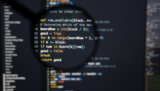 A computer screen displays an abstract algorithm concept/code. Lines of code (text) are visible under a magnifying lens.